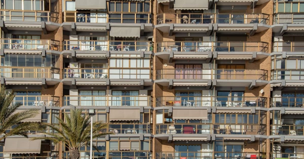 Seafront apartment block with balconies and palm trees in Calpe, on the Costa Blanca