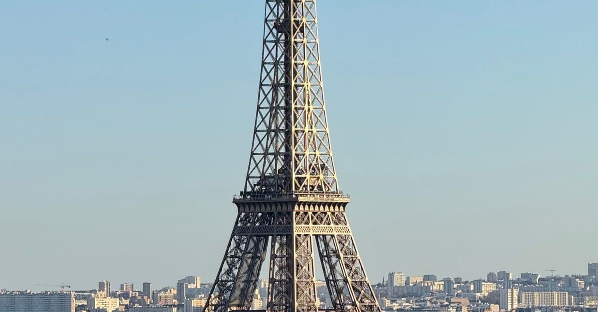 The Eiffel Tower rising above the Paris skyline on a clear day