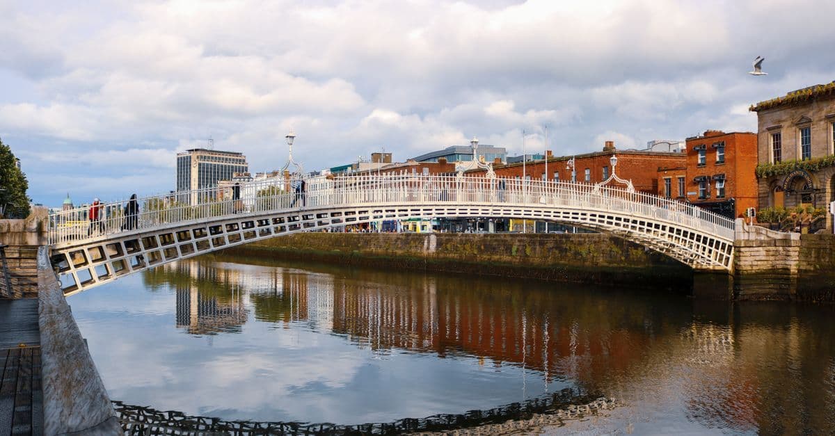 Ha’penny Bridge over the River Liffey in Dublin, reflected in the water