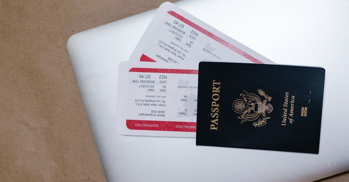 United States passport and travel documents on a laptop